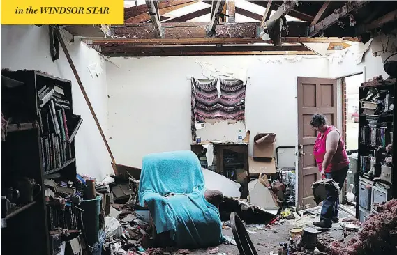  ?? JOE RAEDLE / GETTY IMAGES ?? Amanda Logsdon begins the process of trying to clean up her home Thursday after the roof was blown off by the passing winds of hurricane Michael in Panama City, Fla.