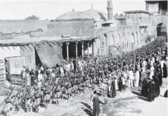  ??  ?? Native troops with the British forces march through New Street, Baghdad. — Otago Witness, 27.3.1918.