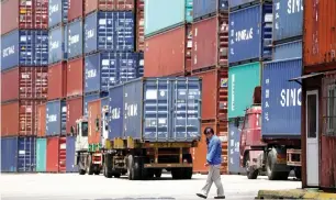  ?? — Reuters ?? Shipping containers are seen at a port in Shanghai. The US has threatened 10 per cent tariffs on $200 billion of Chinese goods — roughly the total amount of US imported from China last year.