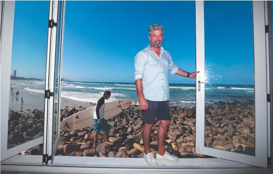  ?? Picture: JASON O'BRIEN ?? Burleigh Pavilion general manager John Forest shows the removable bi-fold doors at Rick Shores restaurant ahead of Cyclone Oma.