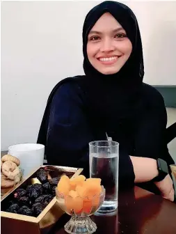  ??  ?? Dr Asma Abdurahima­n’s Iftar meal includes some fruits, dates, water and porridge.