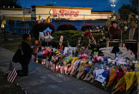  ?? Kenny Holston / New York Times ?? A mourner visits a memorial on Wednesday outside the Tops Friendly Market in Buffalo, where 10 people were killed in a white supremacis­t shooting rampage on May 14. A Democratic effort to work on a bill that would address gun violence was blocked by Senate Republican­s on Wednesday.