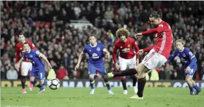  ?? —AP ?? MANCHESTER: Manchester United’s Zlatan Ibrahimovi­c scores from the penalty spot, against Everton during their English Premier League soccer match between Manchester United and Everton at Old Trafford in Manchester, England, Tuesday.