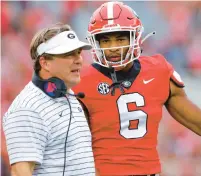  ?? TODD KIRKLAND/GETTY ?? Norfolk’s Daylen Everette talks with Georgia head coach Kirby Smart last season. Everette is slated to start at defensive back for the defending national champions this season.