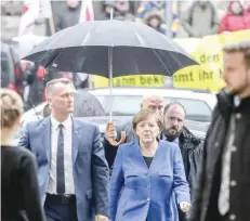  ?? — AFP ?? German Chancellor and Christian Democratic Union (CDU) leader Angela Merkel arrives for talks with the leaders of the conservati­ve CDU/CSU union and the social democratic SPD party on forming a new government on Thursday at the SPD headquarte­rs in...