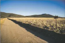  ?? NATHAN BURTON/Taos News ?? A feasibilit­y study is underway to determine if Questa is a suitable place to develop a green hydrogen production facility. The site of the now filled-in tailings ponds for the closed Questa molybdenum mine, shown in this April 8 file photo, is among the properties being discussed as a potential location to build the facility.