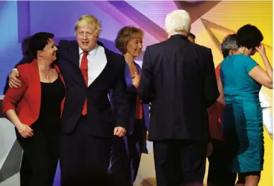  ??  ?? Above Ruth Davidson and Boris Johnson after the EU debate at Wembley, in which they took opposing sides, in June last year. Left Davidson and her partner, Jennifer Wilson, on their way to vote in last year’s Scottish Parliament elections