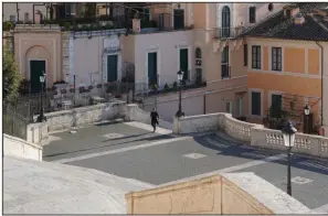  ?? (AP/Andrew Medichini) ?? A solitary person walks the Spanish Steps in Rome on Thursday. Italian officials are warning that they might impose tougher restrictio­ns on outdoor outings as the death toll from the coronaviru­s spikes.