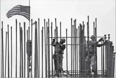  ??  ?? Rodbusters install rebar on the new Comcast Innovation and Technology Center under constructi­on, in Philadelph­ia. The US Commerce Department is expected to report a 0.8 percent contractio­n in first quarter economic output.