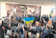  ?? ?? Picasso’s Guernica coloured by Ukrainian flag, main, and left, providing a backdrop to a show of solidarity at United Nations in New York