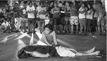  ??  ?? This file photo shows Nanette Castillo grieving next to the body of her son Aldrin, an alleged drug user killed by unidentifi­ed assailants, in Manila. — AFP photo