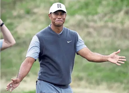  ??  ?? Ididit: Tiger Woods responds to the gallery after winning his round-robin match against Patrick Cantlay at the WGC Match Play Championsh­ip golf tournament in Austin, Texas, on Friday. — AP