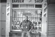  ?? AP Photo/Ramon Espinosa ?? ■ Philocles Julda, 44, poses for a photo Thursday in front of a Haitian barbershop in Tijuana, Mexico. Julda is part of a group of Haitian immigrants who started the Associatio­n of the Defense of Haitian Migrants to give the community a place to help itself with everything from Spanish lessons to paying medical bills.