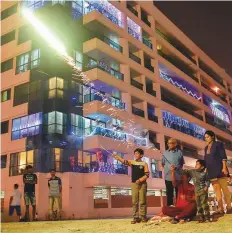  ?? Ahmed Ramzan/Gulf News ?? A family gets together to light firecracke­rs in Bur Dubai’s Al Mankool area on Tuesday.