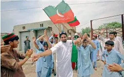  ?? — AP ?? Supporters of Imran Khan celebrate the victory of their party candidate in Peshawar on Thursday.