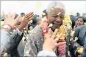  ??  ?? Nelson Mandela closes his eyes as well-wishers in Chatsworth throw petals at him upon his arrival at a sod-turning function for the new youth centre.