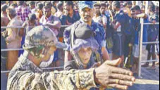  ?? PTI ?? A paramilita­ry soldier guides an elderly women to the entrance of the Lord Ayyappa temple in Sabarimala on Friday.