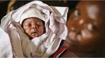  ??  ?? Mary Nabiryo has registered the birth of her one-day-old son, Andrew, to ensure he has legal protection.