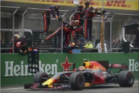  ?? MARK SCHIEFELBE­IN — THE ASSOCIATED PRESS ?? Red Bull driver Max Verstappen of the Netherland­s celebrates with his racing crew after finishing third in the Chinese Formula One Grand Prix at the Shanghai Internatio­nal Circuit in Shanghai, China, Sunday, April 9, 2017.