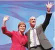  ??  ?? Scotland’s First Minister Nicola Sturgeon joins Deputy First Minister John Swinney on stage following his speech at the Scottish National Party (SNP) conference in Glasgow on Sunday. - Reuters