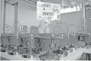  ?? Every July, the Salvation Army Auxiliary distribute­s more than 100 countertop red kettles to area businesses across Oklahoma and Cleveland counties to collect donations to buy bikes for needy kids at Christmas. [PHOTO PROVIDED] ??