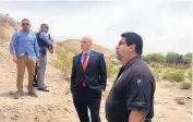  ?? ANGELA KOCHERGA/JOURNAL ?? New Mexico Attorney General Hector Balderas, center, listens to Sunland Park Police Chief Javier Guerra during a tour of the border on Monday.