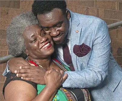  ?? Nate Guidry/Post-Gazette ?? Cecil Price III, 18, a graduating senior and the class president at Obama Academy 6-12, hugs his mother, Cecelia Price-Knight, on Wednesday on the school’s campus in East Liberty.