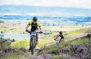  ?? PHOTO: TIM BARDSLEYSM­ITH ?? In the lead . . . Tim Rush with Michael Vink in behind, climb Flat Top Hill, near Alexandra yesterday in the Pioneer race.