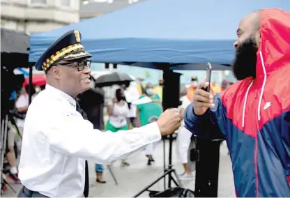  ?? PAT NABONG/SUN-TIMES ?? Chicago Police Supt. David Brown greets community activist William Calloway in West Woodlawn on Friday morning.