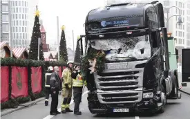  ??  ?? BERLIN: View of the truck that crashed the evening before into a Christmas market at Gedachtnis­kirche church. — AFP