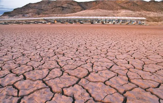  ?? AP FILE PHOTO ?? What was once a marina sits high and dry in 2014 due to Lake Mead receding in the Lake Mead National Recreation Area in Arizona. Arizona missed a federal deadline last month to approve a plan to limit water use.