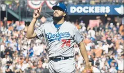  ?? Thearon W. Henderson Getty Images ?? KENLEY JANSEN walks off the mound after striking out San Francisco’s Brandon Belt for the final out of the Dodgers’ 2-1 victory in 10 innings.