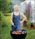  ?? ASSOCIATED PRESS ?? THIS UNDATED PHOTO provided by Clarkson Potter/Penguin Random House shows Erin French, owner of The Lost Kitchen restaurant in Freedom, Maine, grilling burgers with an Airstream trailer in the background.