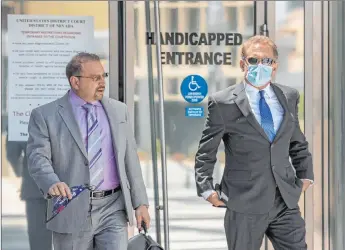  ?? L.E. Baskow Las Vegas Review-journal @Left_eye_images ?? Attorney Marc Victor, left, walks out of the Lloyd George U.S. Courthouse on Tuesday with his client Douglas Haig after Haig ’s sentencing on a charge of manufactur­ing ammunition without a license.