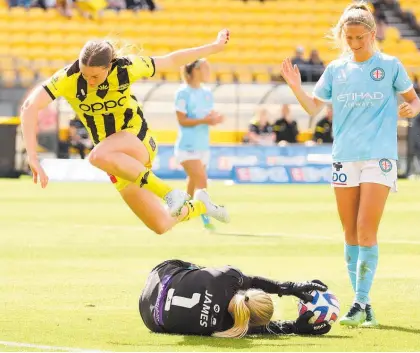  ?? Photo / Photosport ?? Ava Pritchard, who scored the Phoenix goal, tumbles over the top of Melbourne City’s Sally James.