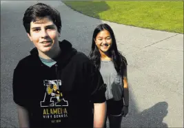  ?? Jeff Chiu ?? The Associated Press Alameda High School students Henry Mills, left, and Kristen Wong on the school’s campus in Alameda, Calif., on Aug. 23.