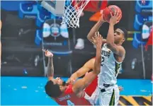  ?? AP PHOTO/MICHAEL CONROY ?? Baylor guard Jared Butler shoots over Houston forward Justin Gorham during their teams’ Final Four matchup Saturday night in Indianapol­is. Baylor cruised to reach Monday night’s title game.