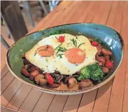  ?? COURTESY OF THE LOWLANDS GROUP ?? Café Benelux's Easter menu includes a duck sausage hash with smoked duck and badger ham, broccoli and breakfast potatoes, topped with sunny side up eggs.