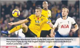  ??  ?? Wolverhamp­ton Wanderers’ Conor Coady (left) vies with Tottenham Hotspur’s Harry Kane (right) during their English Premier League match at the Molineux stadium yesterday. –