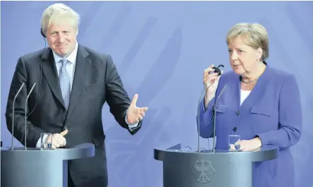  ??  ?? GERMANY’S Chancellor Angela Merkel and British Prime Minister Boris Johnson attend a joint press conference in Berlin on Wednesday. Johnson’s stance, that Britain will leave the EU with or without a deal, has alienated many in Europe. | AP