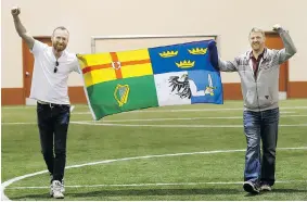  ?? RICHARD MARJAN/The StarPhoeni­x ?? John Lawlor, left, and Andy Doyle of the Irish soccer team pose for a photo with the team
flag on Wednesday. They plan to repeat as champions in the Saskatoon World Cup.