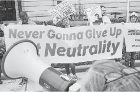  ?? Chip Somodevill­a / Getty Images file ?? Proponents of net neutrality protest in May against Federal Communicat­ion Commission Chairman Ajit Pai in Washington.