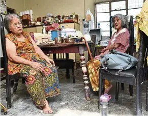  ??  ?? Neoh Say Im, 78 (left) and Cheang Hooi Pow, 80 (right) had to be carried to safety as the floodwater­s charged into their home in Penang. Even though the senior citizens live with their family in Lengkok P. Ramlee, it was a harrowing experience for them.