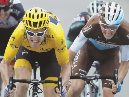  ?? AP PHOTO ?? STRAINING FOR THE LINE: Overall leader Geraint Thomas (left) grimaces as he sprints with France’s Romain Bardet (right) toward the finish line of yesterday’s 19th stage of the Tour de France in Laruns, France.