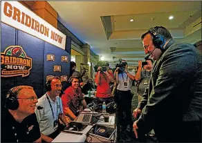  ?? Associated Press ?? In the spotlight: Arkansas football coach Bret Bielema, right, speaks with media in a radio interview during the Southeaste­rn Conference's annual media gathering, Monday in Hoover, Ala.