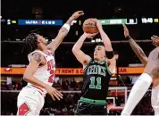  ?? Charles Rex Arbogast/Associated Press ?? The Celtics’ Payton Pritchard shoots as the Bulls’ Dalen Terry defends during the first half Saturday.