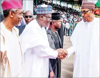  ??  ?? President Buhari in a handshake with Lawan ... Osinbajo and Speaker Gbajabiami­la watch