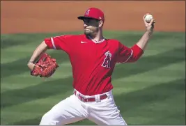  ?? MATT YORK — THE ASSOCIATED PRESS ?? Angels starting pitcher Andrew Heaney could benefit from a six-man starting rotation.
THE GAME: Taylor Ward homered and tripled in the Angels’ 6-4 loss to the Texas Rangers on Tuesday afternoon in a Cactus League game at Surprise Stadium. PITCHING REPORT: Lefthander Andrew Heaney gave up five runs in 4-2⁄3 innings, on 97 pitches. In the first inning, he allowed two infield singles and then a two-run double. The Rangers hit him harder in the fourth and fifth, including a homer by Adolis Garcia. Heaney struck out six and walked one. Heaney has allowed 10 earned runs in 14-1⁄3 innings (6.28) this spring, with 16 strikeouts. Heaney said he felt like he was starting to get the feel for his breaking ball in the fifth inning, and he tried to talk manager Joe Maddon into leaving him in the game, but Maddon had already signaled for the bullpen. “I just felt like that last inning I had a better feel for the things I was trying to do,” Heaney said. “I don’t know why it took me 80 pitches to get that feel, but it felt good.”