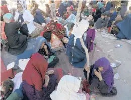  ?? RAHMAT GUL/AP ?? Displaced Afghan women from northern provinces, who fled their homes due to fighting, receive medical care in a public park Tuesday in Kabul, Afghanista­n.