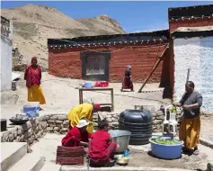  ??  ?? Indian Buddhist monks carrying out daily chores at the monastery.